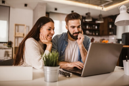 couple staring at a laptop